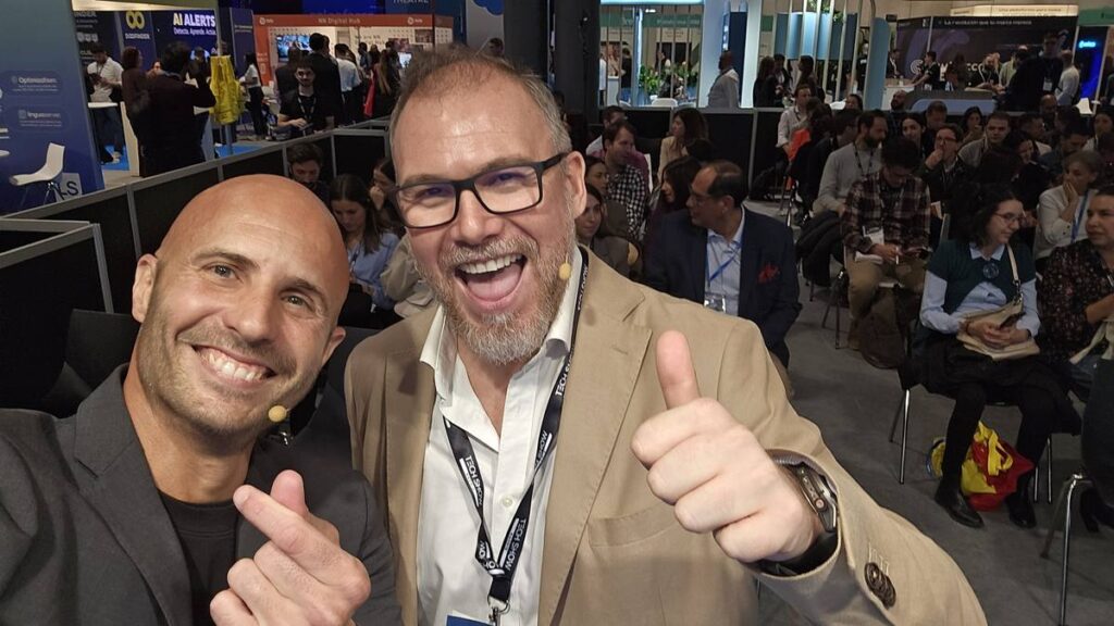 Victor de la Fuente and Inaki Tovar smiling and giving a thumbs up at eShow Madrid, part of Tech Show Madrid